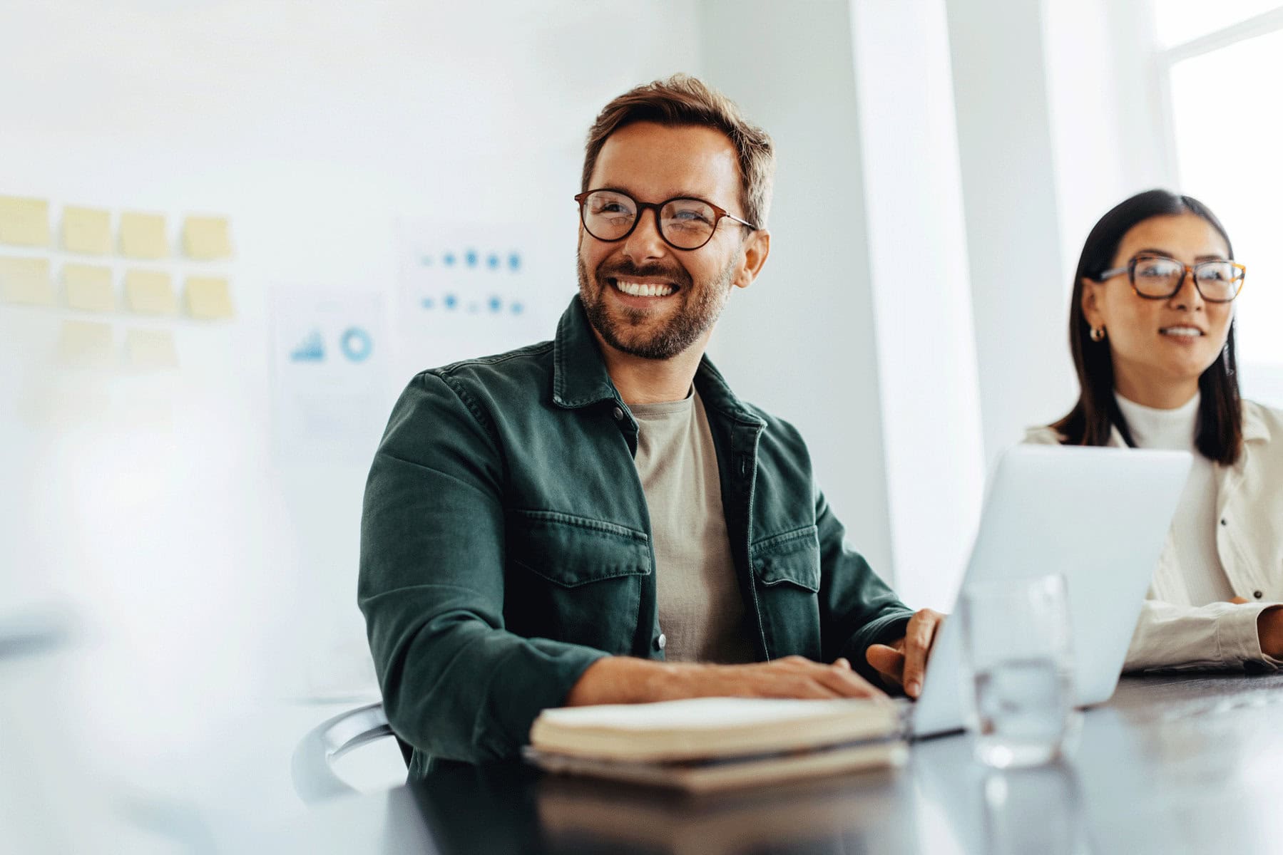 A happy man in an office, illustrating the power that effective IT solutions can have on a business.